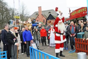 Santa Claus shows his strength. (Photo by Hasse Ferrold, The Danish Pioneer's Staff Photographer)