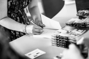 K.B. Jensen autographs her novel at her book launch in 2014. (File Photo: JonasVandall.dk)