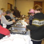 Danish Brotherhood Lodge #35 members and guests line up the delicious pork chop buffet. (Photo courtesy of The Danish Pioneer Newspaper)