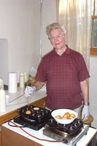 Vagn Jensen made æbleskiver for the Danish Folk Schoolers at the Danish American Center in Minneapolis for our Farewell Breakfast in August 2013. (Photo courtesy of The Danish Pioneer)